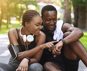 Young African American couple seated and resting after a workout session. 